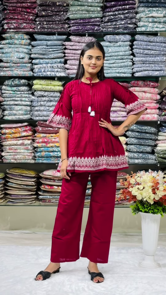 Women’s Red Embroidered Kurti Pant Set – White Threadwork Details with Boutique Shelf Backdrop