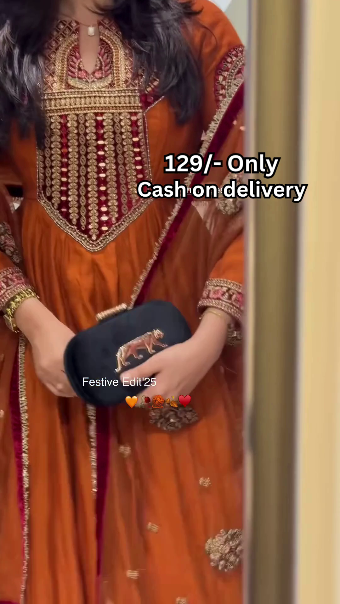 Women’s Orange Embroidered Kurti with Gold & Red Threadwork – Festive Ethnicwear Styled with Black Clutch Accessory