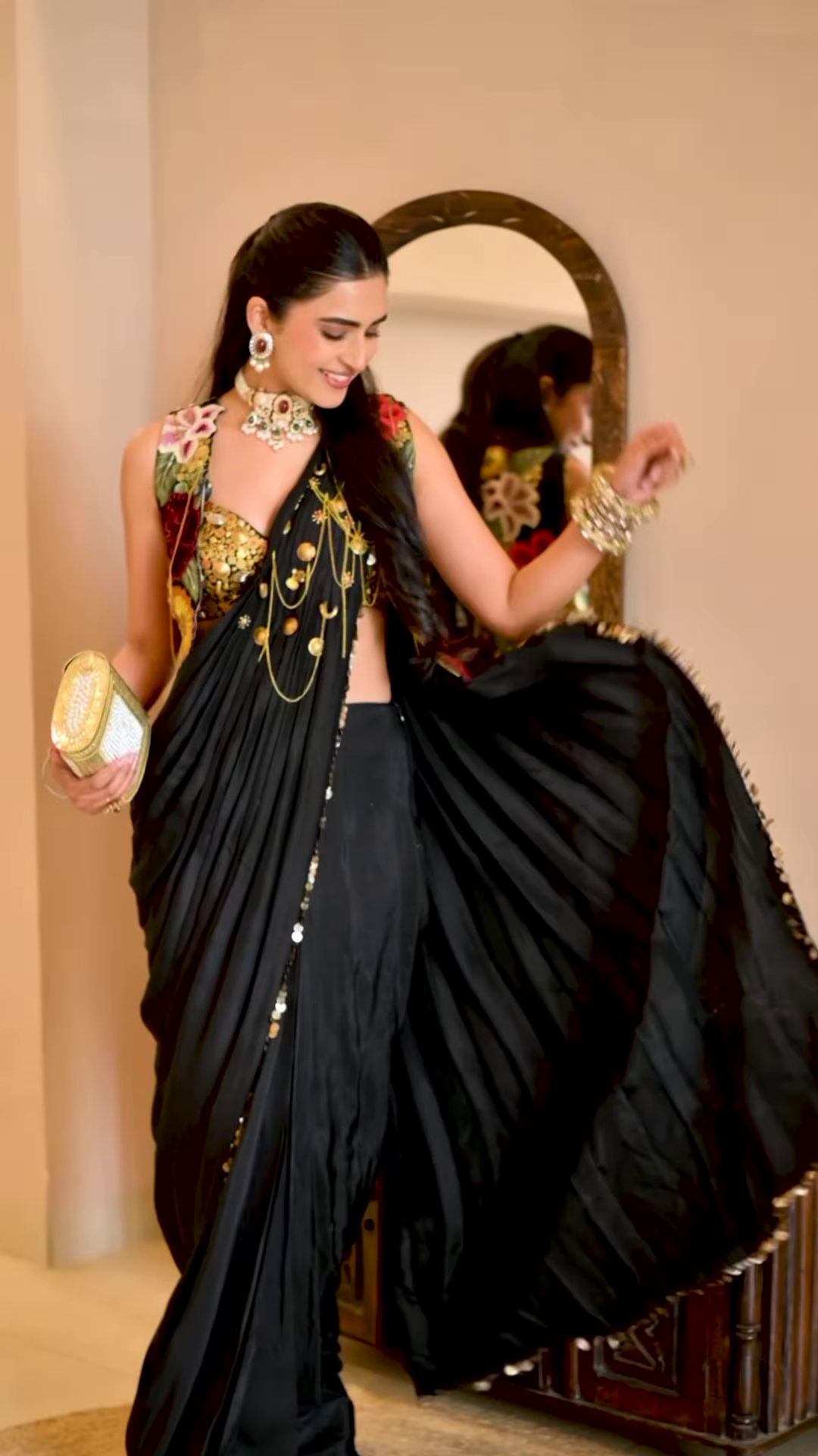 Women’s Black Saree with Gold Embellishments & Pleated Draping – Elegant Ethnicwear Styled with Traditional Bracelet