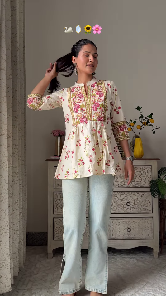 Women’s Sleeveless Red Floral Top with Light Blue Flared Jeans – Indo-Western Casualwear Styled with Vintage Decor Backdrop