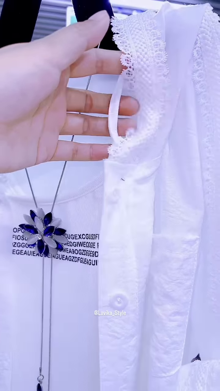 Elegant White Layered Outfit with Striking Blue Necklace