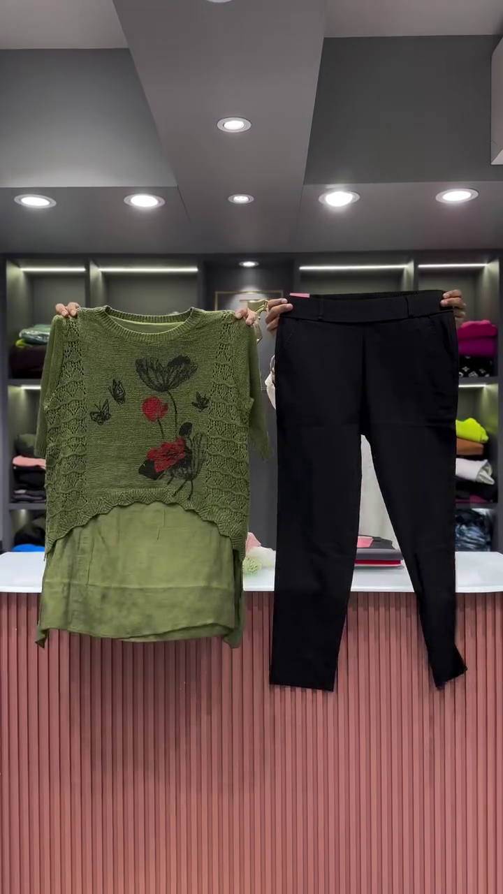 Black Open-Knit Top with Floral Appliqués and Gray Pants