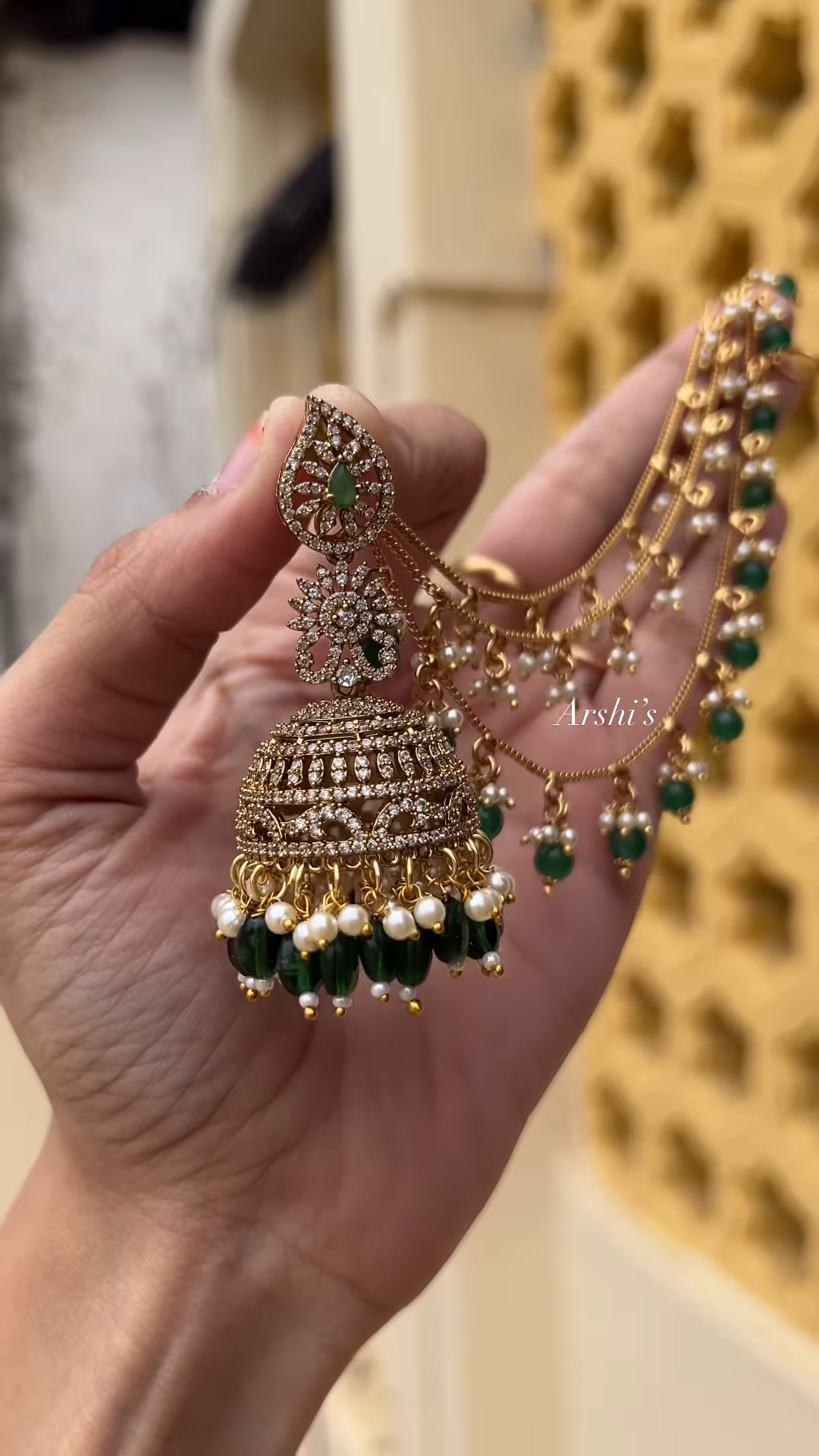 Sparkling AD Stone Jhumka Earrings with Green Beads and Pearl Chain Earchain