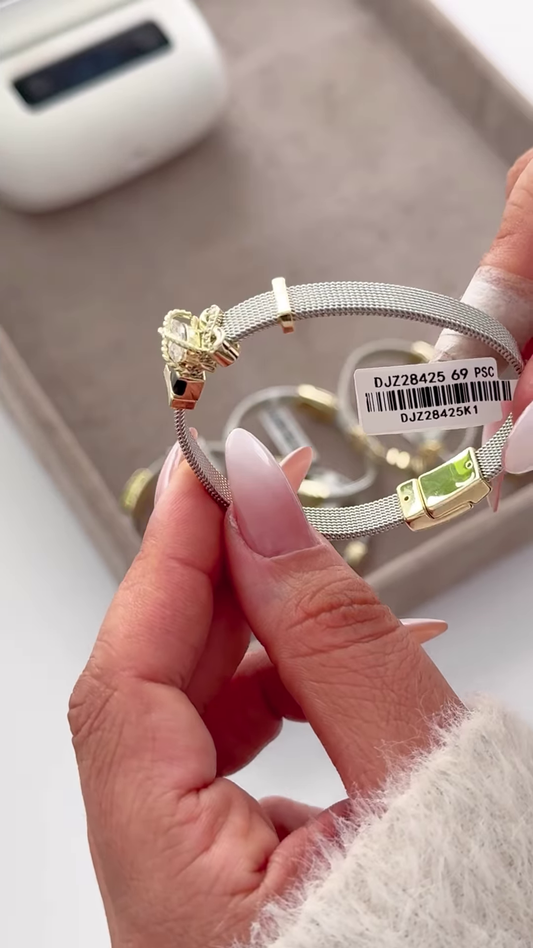 Elegant Silver-Toned Mesh Bracelet with Gold Accents and Crown Charm