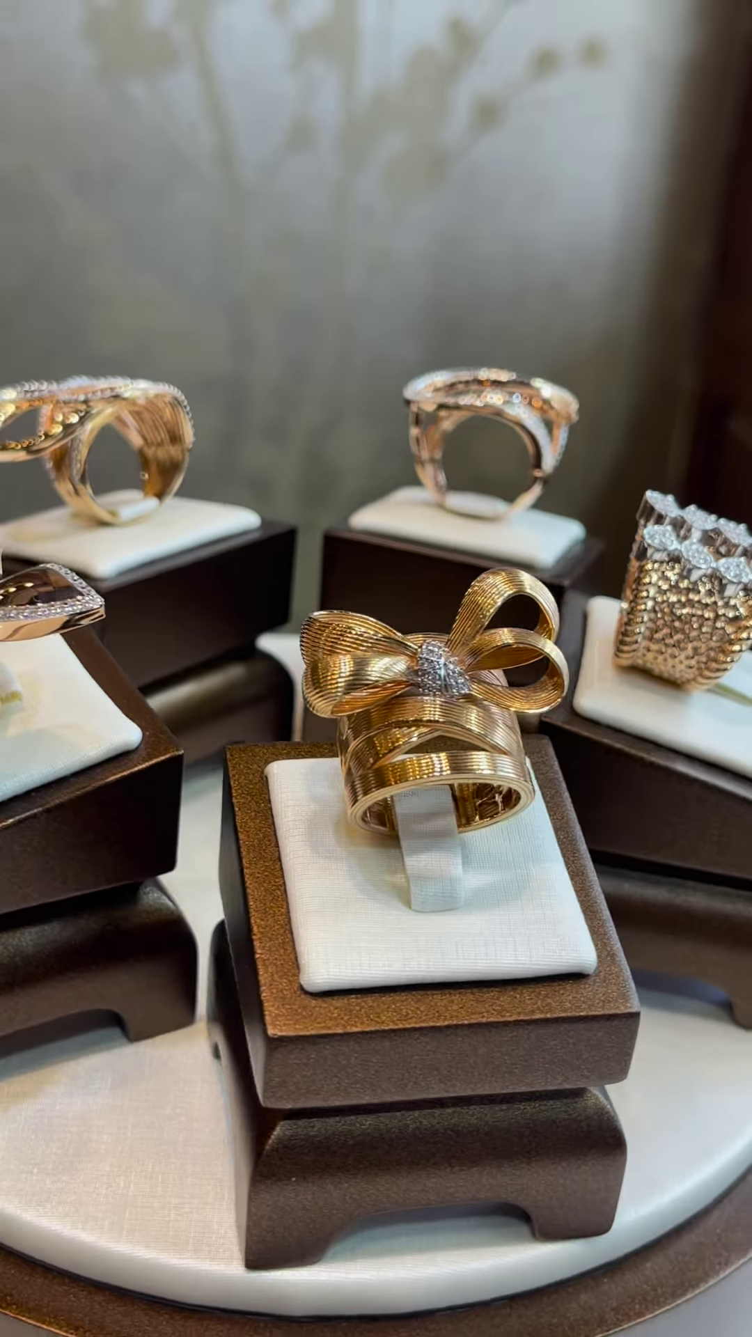 Elegant Gold-Toned Sculptural Bow Ring with Dazzling Clear Gemstone Accents