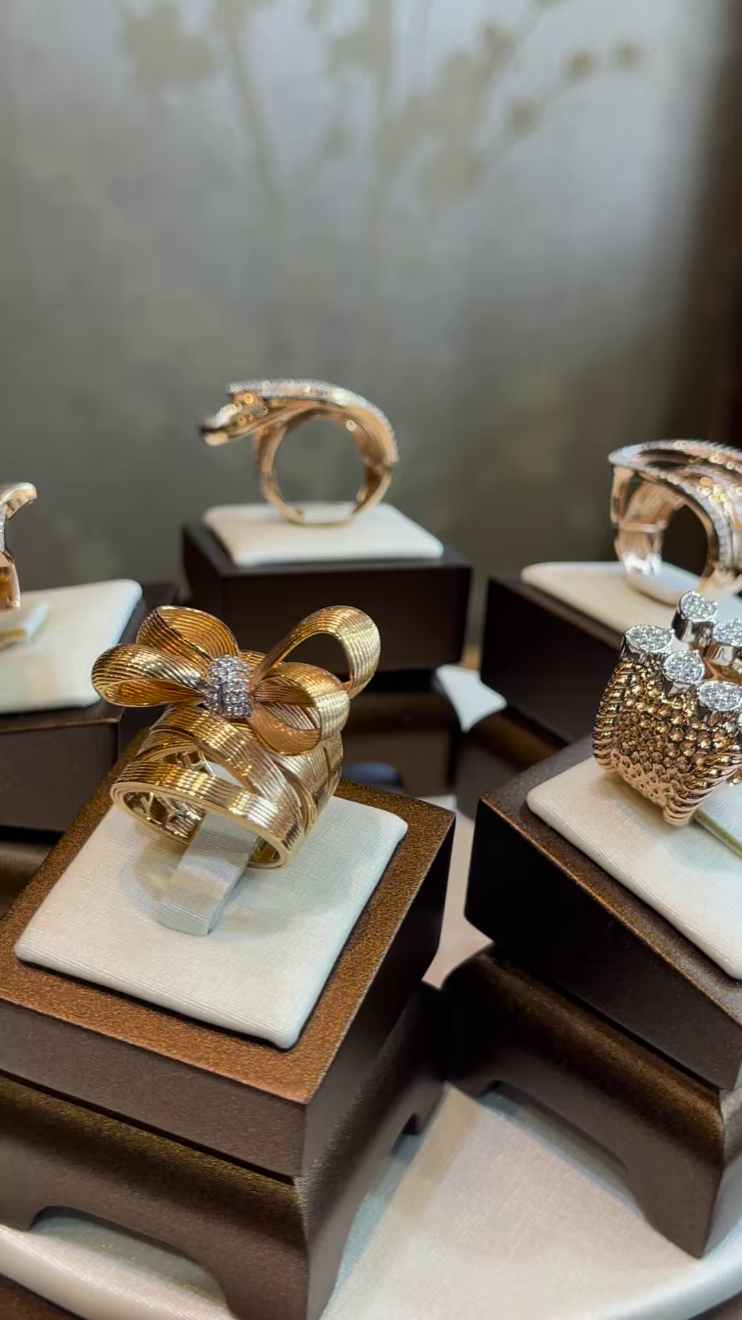 Elegant Gold-Toned Sculptural Bow Ring with Dazzling Clear Gemstone Accents