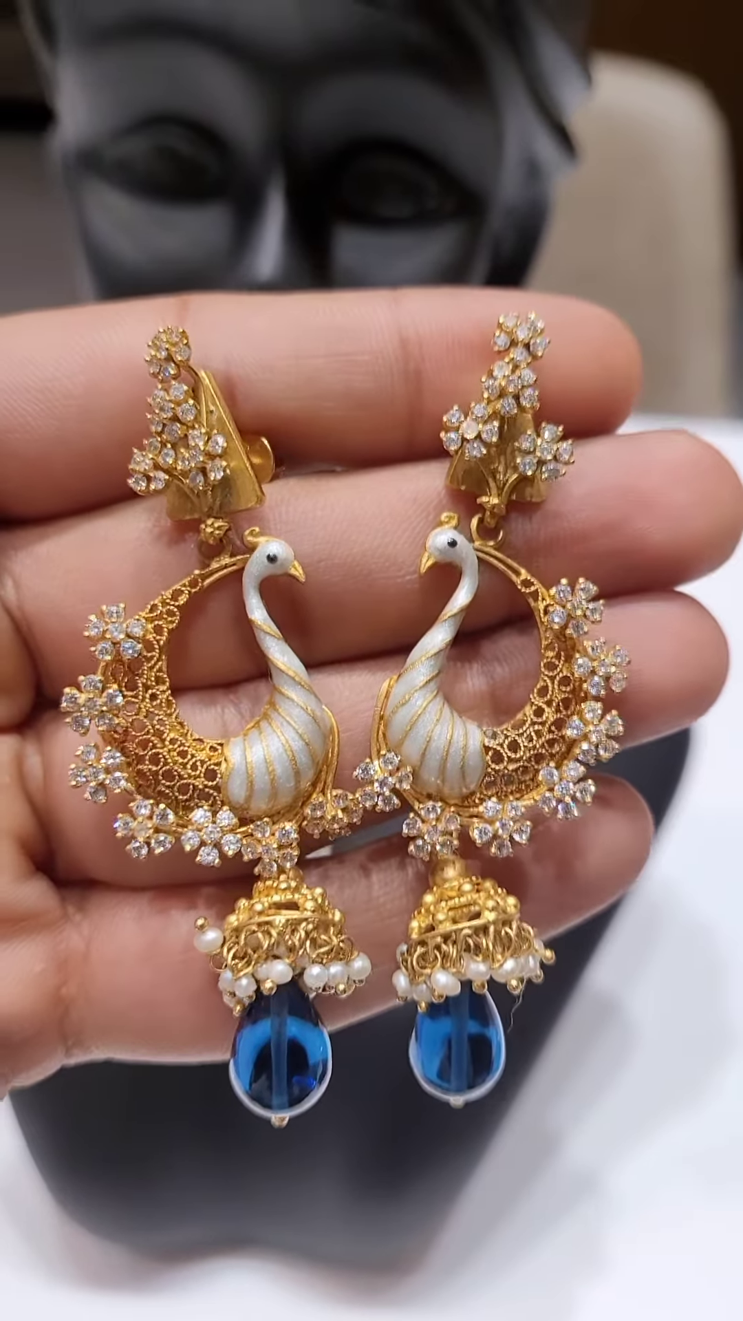 Exquisite Gold-Toned Peacock Pendant with Dazzling Clear Gemstones, Pearl Strands, and Blue Drop