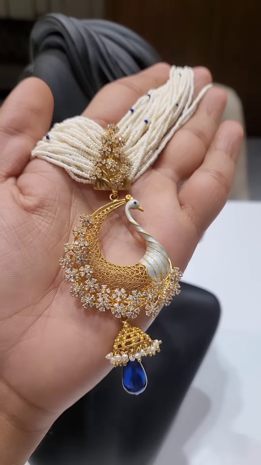 Exquisite Gold-Toned Peacock Pendant with Dazzling Clear Gemstones, Pearl Strands, and Blue Drop
