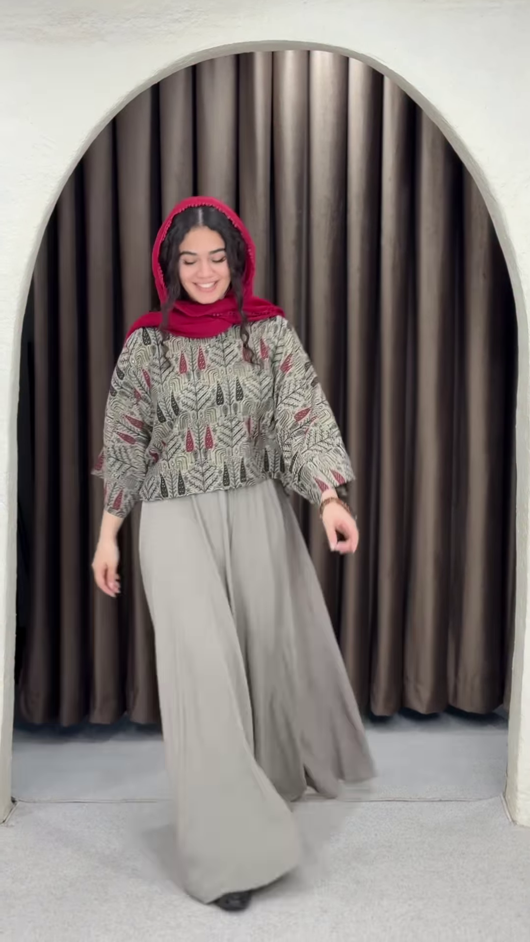 Women’s Red Printed Headscarf with Abstract Top & Gray Wide-Leg Pants – Boho Urban Doorway Portrait Ensemble