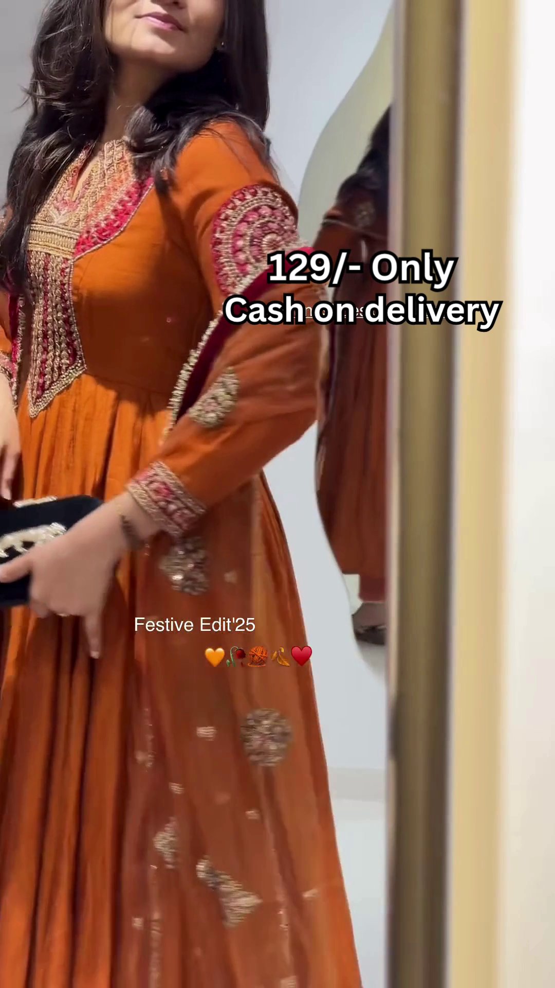 Women’s Orange Embroidered Kurti with Gold & Red Threadwork – Festive Ethnicwear Styled with Black Clutch Accessory