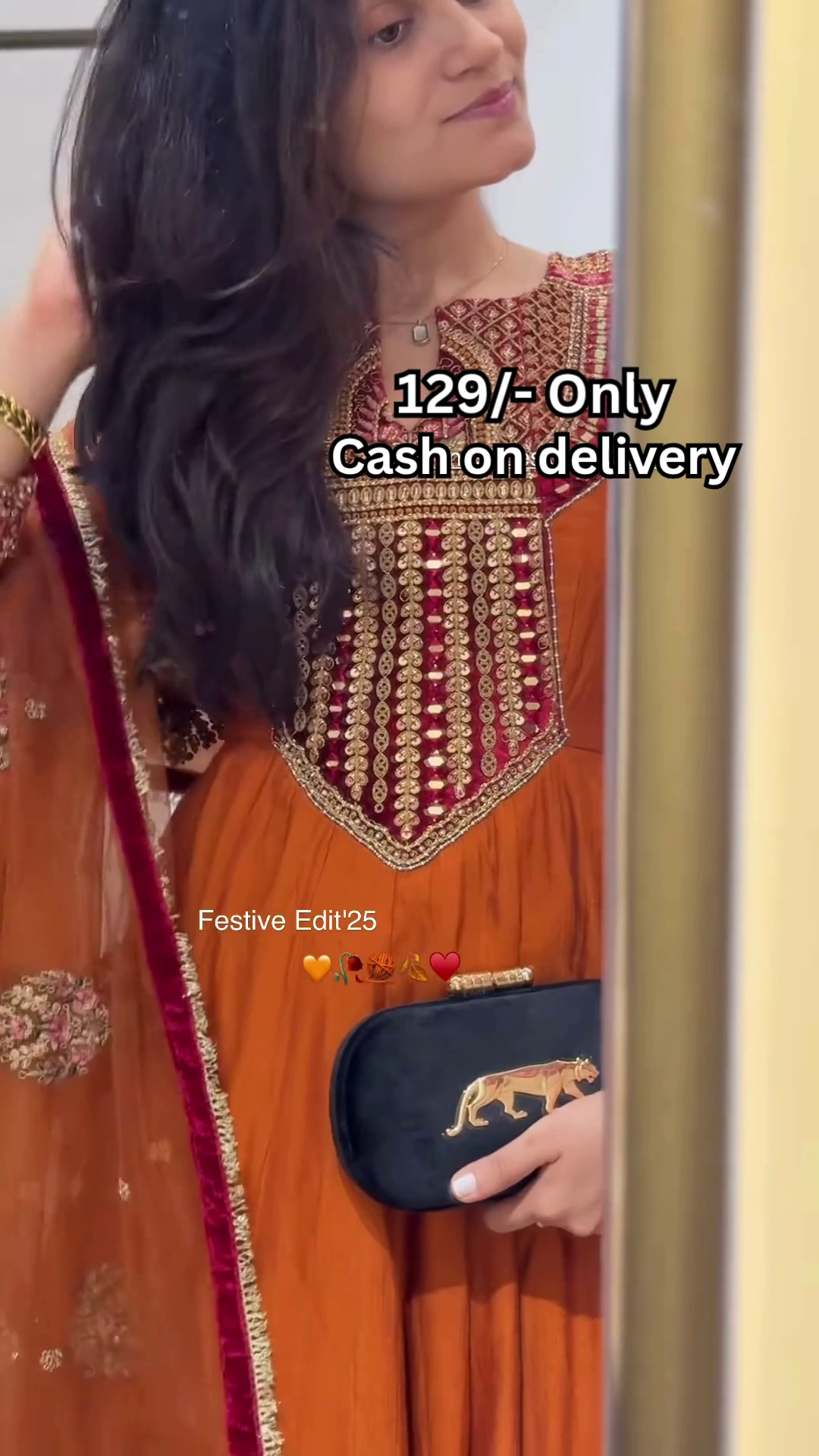 Women’s Orange Embroidered Kurti with Gold & Red Threadwork – Festive Ethnicwear Styled with Black Clutch Accessory