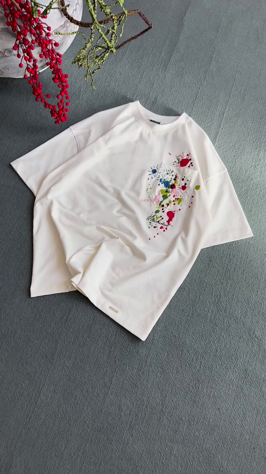 Unisex White & Beige T-Shirts with Colorful Paint Splatter and Pocket Embroidery – Artistic Casualwear for Everyday Styling