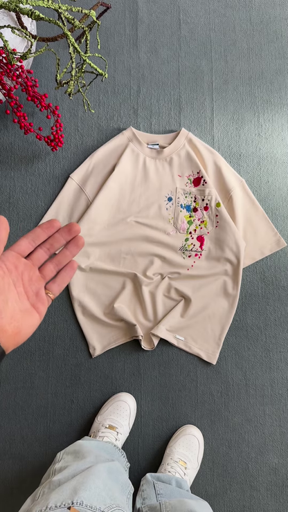 Unisex White & Beige T-Shirts with Colorful Paint Splatter and Pocket Embroidery – Artistic Casualwear for Everyday Styling