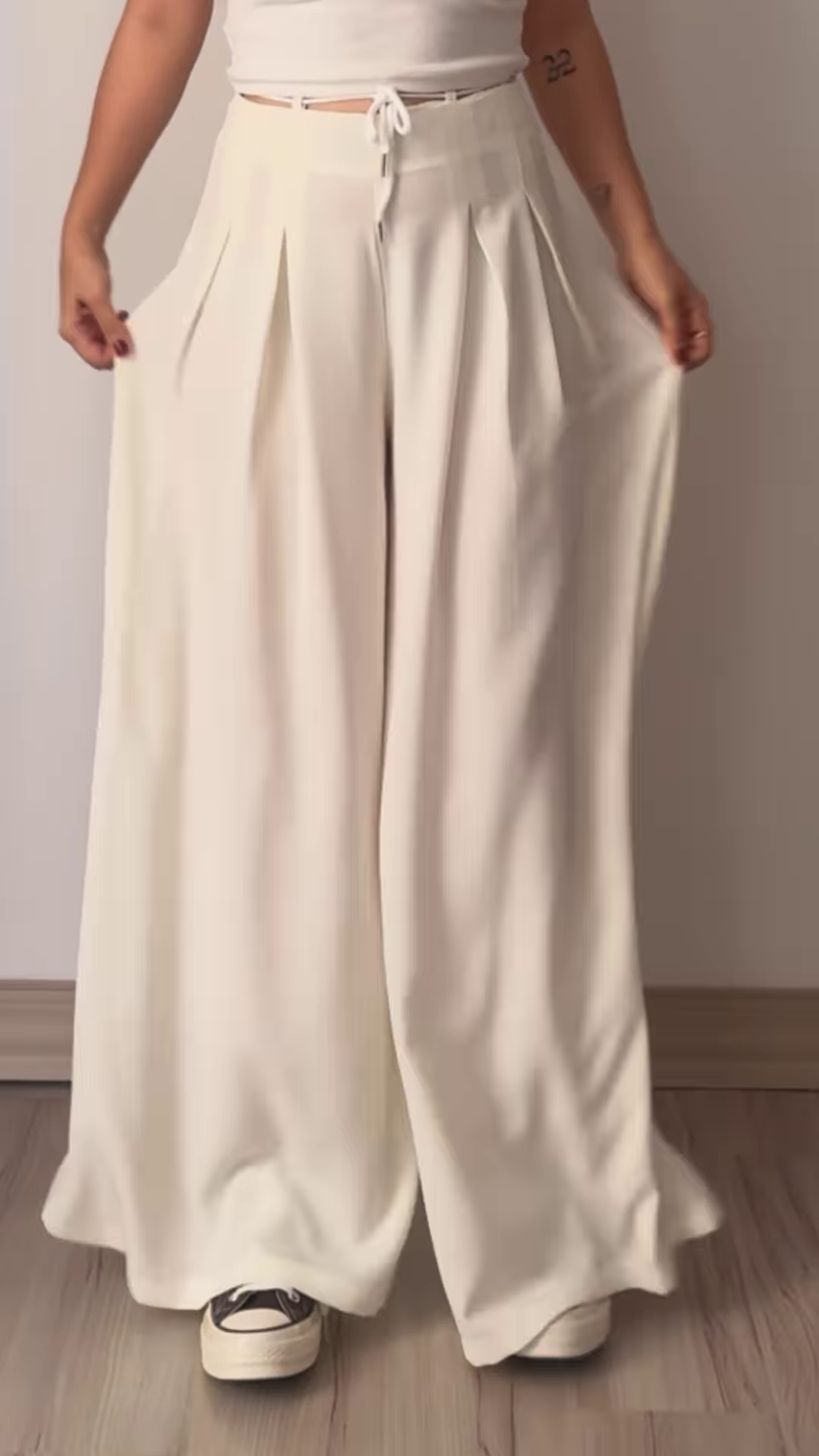 Women’s Beige Wide-Leg Pleated Pants with Drawstring Waist – Flowing Casualwear Styled with White Sneakers
