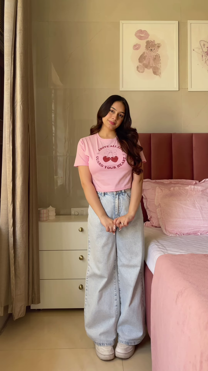 Pink Graphic T-Shirt with “Weekend Vibes” Print Paired with Light Blue Wide-Leg Jeans