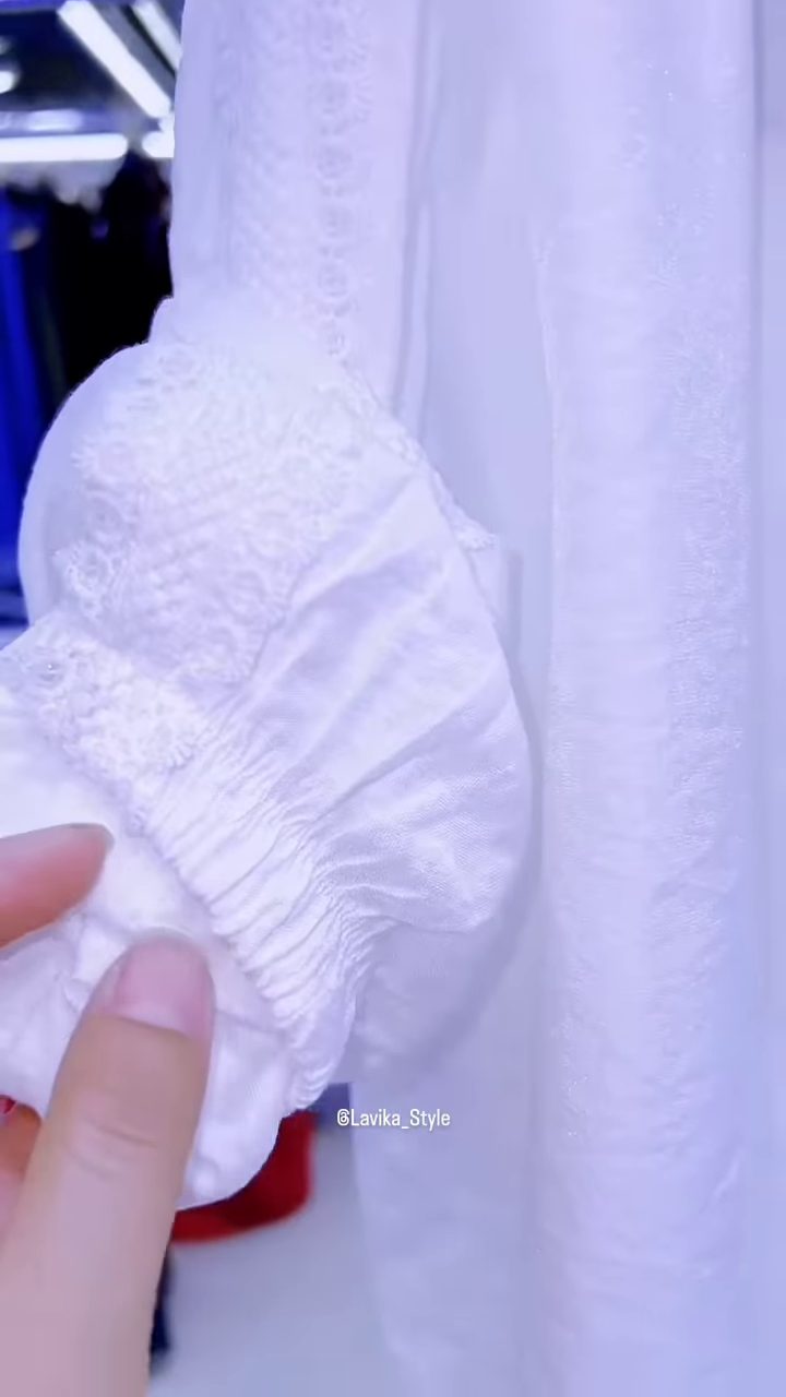 Elegant White Layered Outfit with Striking Blue Necklace