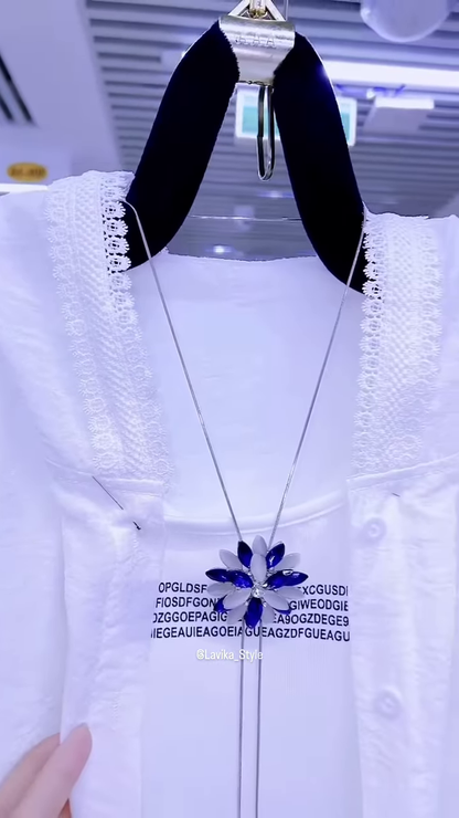 Elegant White Layered Outfit with Striking Blue Necklace