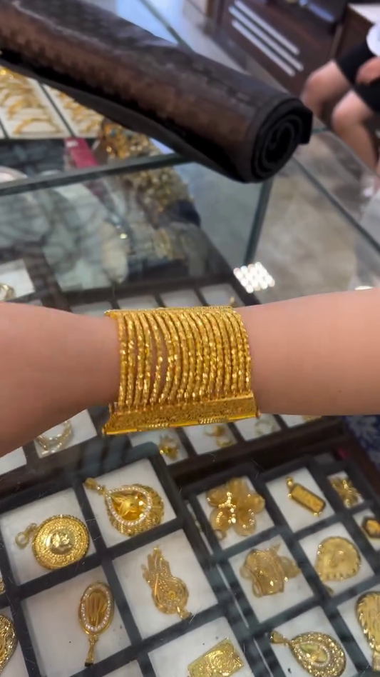 Set of Multiple Ornate Gold Bangles with Intricate Texturing