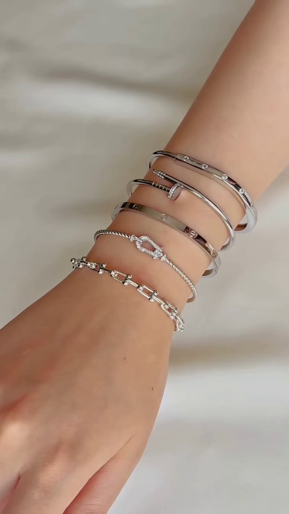 Layered Gold-Toned Bracelet Stack with Cartier Love Inspired Bangle and Knot Design