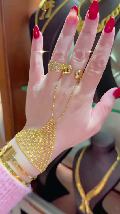Ornate Gold-Toned Hand Chain Bracelet with Intricate Mesh and Ring Attachments