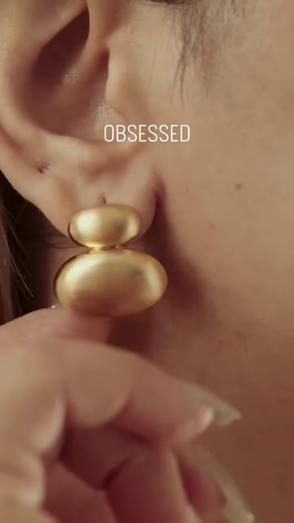Close-Up of Stylish Gold-Toned Earrings: Teardrop, Stud, and Mesh Hoop