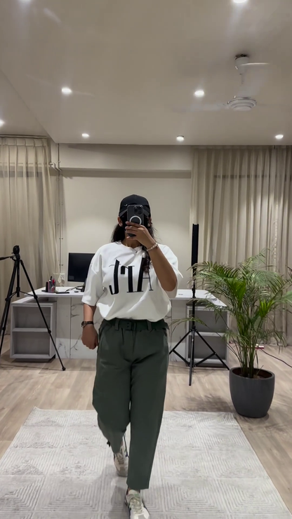 Casual Chic Outfit: White Graphic Tee, Maroon Wide-Leg Pants, and Black Cap