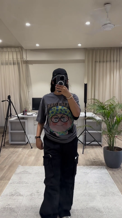 Urban Chic Outfit: White Graphic Tee, Rust Cargo Pants, and Black Cap