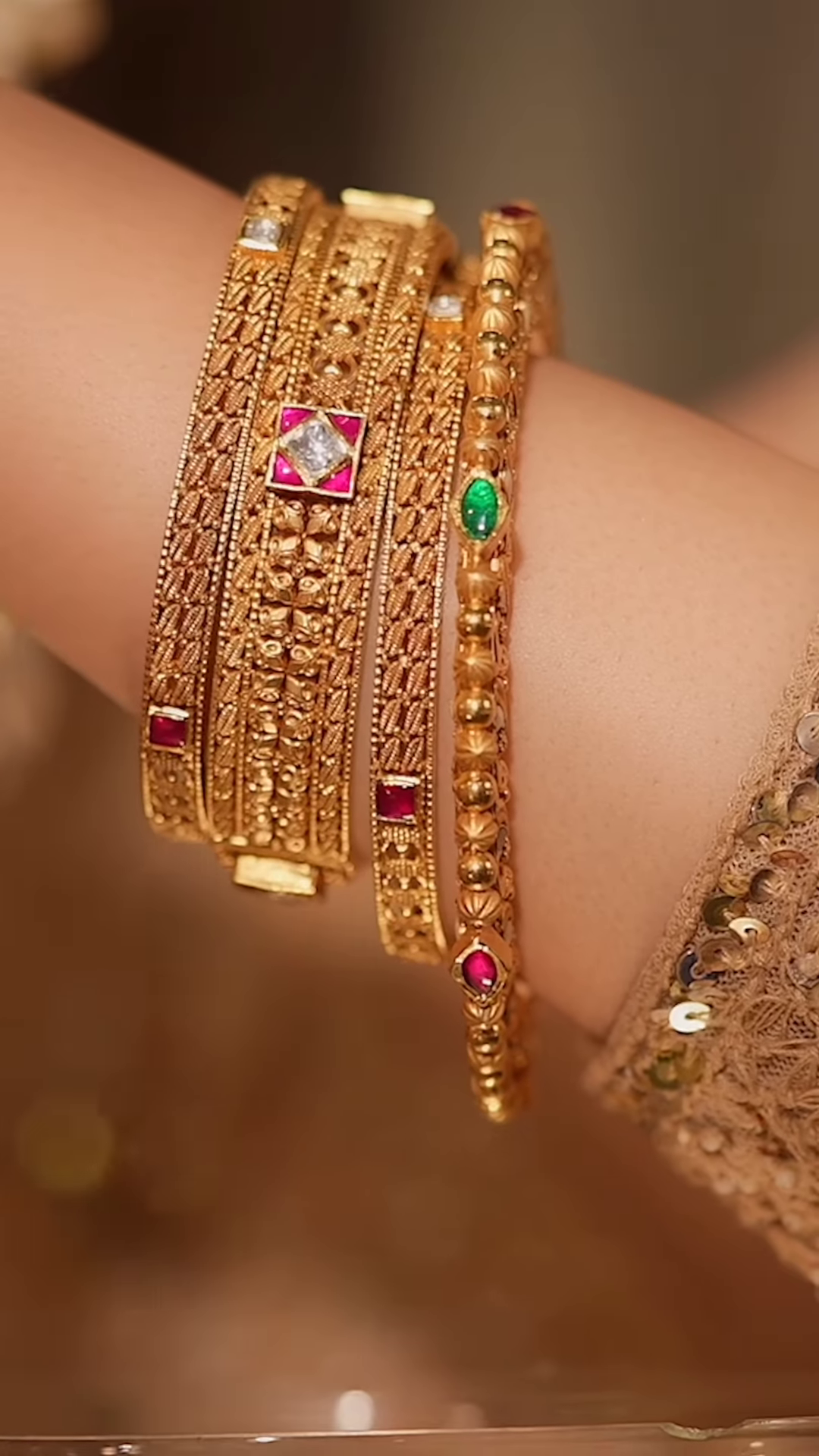 Ornate Gold-Toned Bangle with Kundan, Emerald, and Pearl Detailing