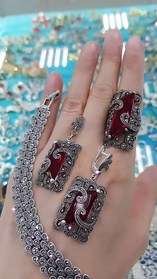 Ornate Oxidized Silver-Toned Jewelry Set with Bold Red Gemstones and Intricate Detailing