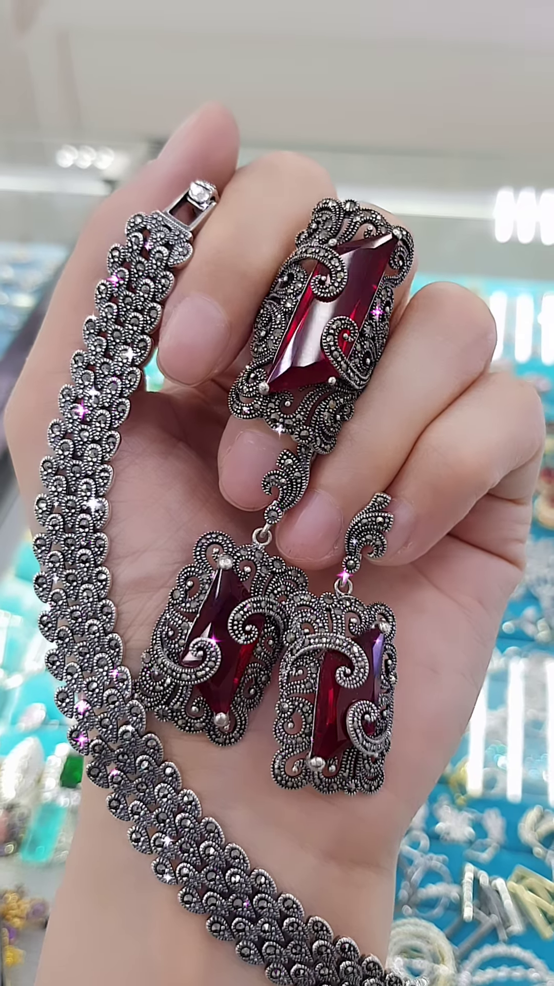 Ornate Oxidized Silver-Toned Jewelry Set with Bold Red Gemstones and Intricate Detailing