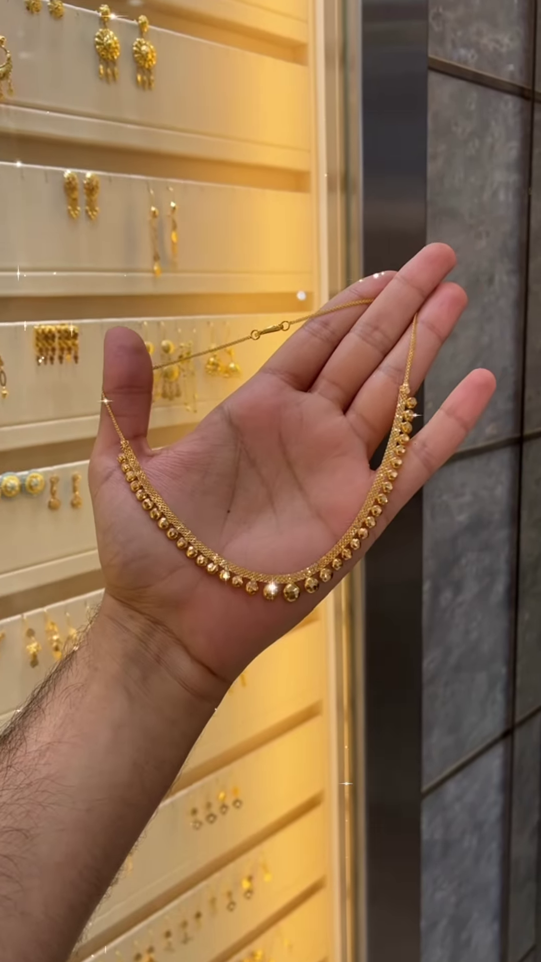 Elegant Gold-Toned Necklace with Spherical Beads and Interwoven Chain Detail