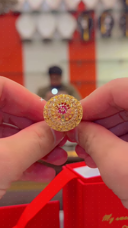 Ornate Gold-Toned Ring with Red Gemstone Center and Circular Filigree Design