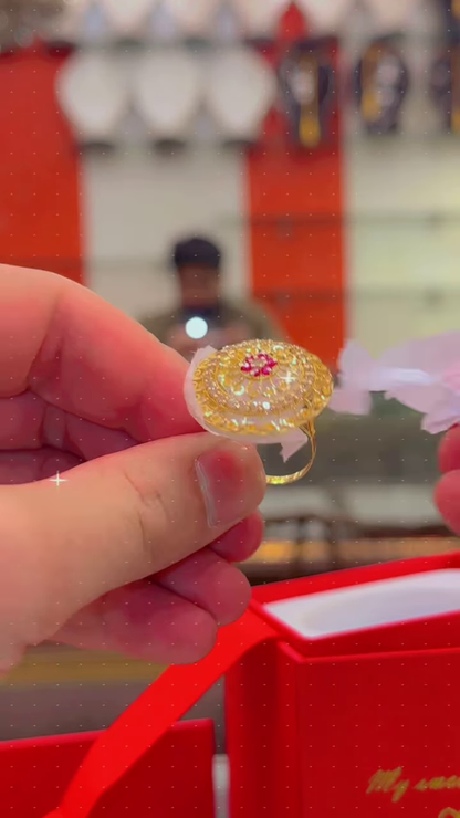 Ornate Gold-Toned Ring with Red Gemstone Center and Circular Filigree Design