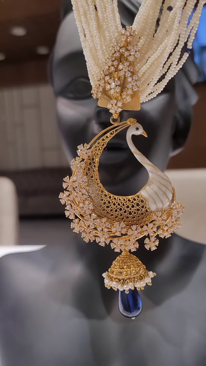 Exquisite Gold-Toned Peacock Pendant with Dazzling Clear Gemstones, Pearl Strands, and Blue Drop