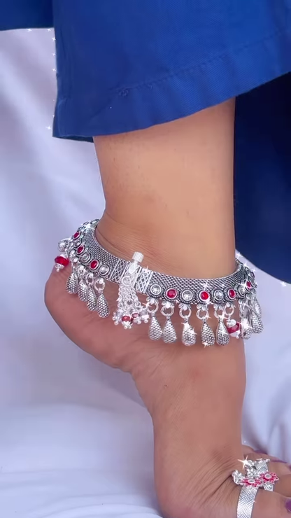 Ornate Silver-Toned Anklet with Red Gemstone Accents and Dangle Charms